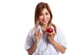 Young Asian female doctor listening to an apple with a stethoscope Royalty Free Stock Photo