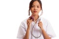 Young Asian female doctor listening to an apple with a stethoscope Royalty Free Stock Photo