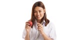 Young Asian female doctor listening to an apple with a stethoscope. Royalty Free Stock Photo