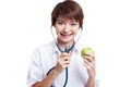 Young Asian female doctor listening to an apple with a stethoscope. Royalty Free Stock Photo