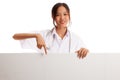 Young Asian female doctor point down to blank sign Royalty Free Stock Photo