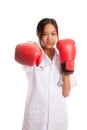 Young Asian female doctor punch with boxing glove Royalty Free Stock Photo