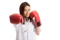 Young Asian female doctor punch with boxing glove. Royalty Free Stock Photo