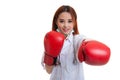 Young Asian female doctor punch with boxing glove. Royalty Free Stock Photo