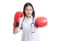 Young Asian female doctor punch with boxing glove. Royalty Free Stock Photo