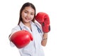 Young Asian female doctor punch with boxing glove. Royalty Free Stock Photo