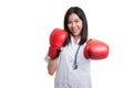 Young Asian female doctor punch with boxing glove. Royalty Free Stock Photo