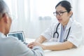 Female doctor reassuring senior male patient. Royalty Free Stock Photo