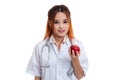 Young Asian female doctor show apple. Royalty Free Stock Photo