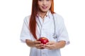 Young Asian female doctor show an apple. Royalty Free Stock Photo