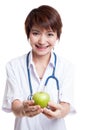 Young Asian female doctor show an apple. Royalty Free Stock Photo