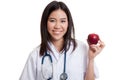 Young Asian female doctor show an apple. Royalty Free Stock Photo