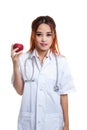 Young Asian female doctor smile show an apple. Royalty Free Stock Photo
