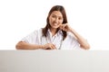 Young Asian female doctor standing behind blank white billboard. Royalty Free Stock Photo