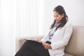 Young asian Female doctor, writing on a clipboard Royalty Free Stock Photo