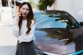 Young asian female driver calling a car insurance company representative about accident claim process Royalty Free Stock Photo