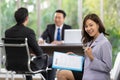 Young Asian female employee happy holding a resume expresses joy after successful  interview with the Human Resources Manager Royalty Free Stock Photo