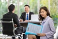 Young Asian female employee holding a resume waits for a job interview with the human resource manager Royalty Free Stock Photo