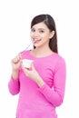 Young asian female enjoying taste of yogurt isolated on white Royalty Free Stock Photo