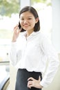 Young Asian female executive talking on phone Royalty Free Stock Photo