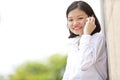 Young Asian female executive talking on phone