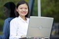 Young Asian female executive using laptop