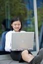 Young Asian female executive using laptop