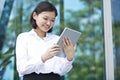 Young Asian female executive using tablet