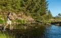 A young asian female fly fishing on a river on a summers evening Royalty Free Stock Photo