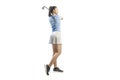 Young asian female gazing the golf ball after hit the ball with iron club in full swing pose Royalty Free Stock Photo