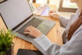 Young asian female graphic designer working in her office workplace, using laptop computer Royalty Free Stock Photo