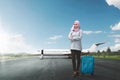 Young asian female muslim with suitcase going traveling Royalty Free Stock Photo