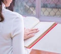 Young Asian female student portrait concentrate on studying and reading textbook in university library. Preparation for exams or