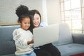 Young Asian female teacher tutoring to African American female students at home. Royalty Free Stock Photo