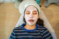 Young Asian female teenager getting her acne and facial treatment