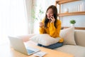 Young Asian female wearing glasses using laptop Royalty Free Stock Photo