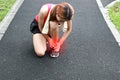 Young Asian fitness woman runner suffering from broken twisted ankle. Running injury accident concept