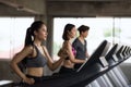 Young Asian friends run on machine at gym Royalty Free Stock Photo