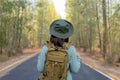 Young Asian girl with a backpack and hat hiking in the mountains during the summer season Royalty Free Stock Photo