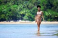 Young asian girl in bikini walking at tropical beach Royalty Free Stock Photo