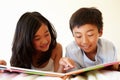 Young Asian girl and boy reading book Royalty Free Stock Photo