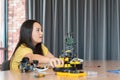 Young Asian Girl Building and Programming Robotic Arm in STEM Class, Student Assembling Robot Components for Science and Royalty Free Stock Photo