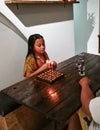 Young Asian girl celebrating a simple birthday at home with family