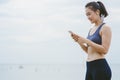 Young Asian Girl Choose Music for Running on the beach. Royalty Free Stock Photo