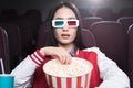 young asian girl in 3d glasses with big basket of popcorn watching movie Royalty Free Stock Photo