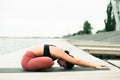 Young Pretty asian girl doing yoga outdoors on the pier by the lake Royalty Free Stock Photo