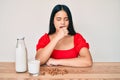 Young asian girl drinking healthy almond milk feeling unwell and coughing as symptom for cold or bronchitis Royalty Free Stock Photo