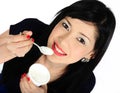 Young asian girl eating yogurt Royalty Free Stock Photo