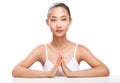 Young Asian girl with hands folded in harmony symbol