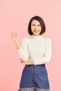 Young Asian girl have good idea. Happy smiling woman isolated on pink background. Copy space